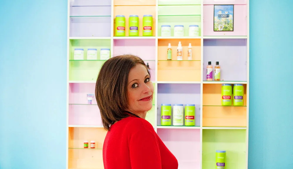 Gen in front of her product shelves